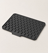 Non-slip silicone sink drying mat draining dishes beside the sink